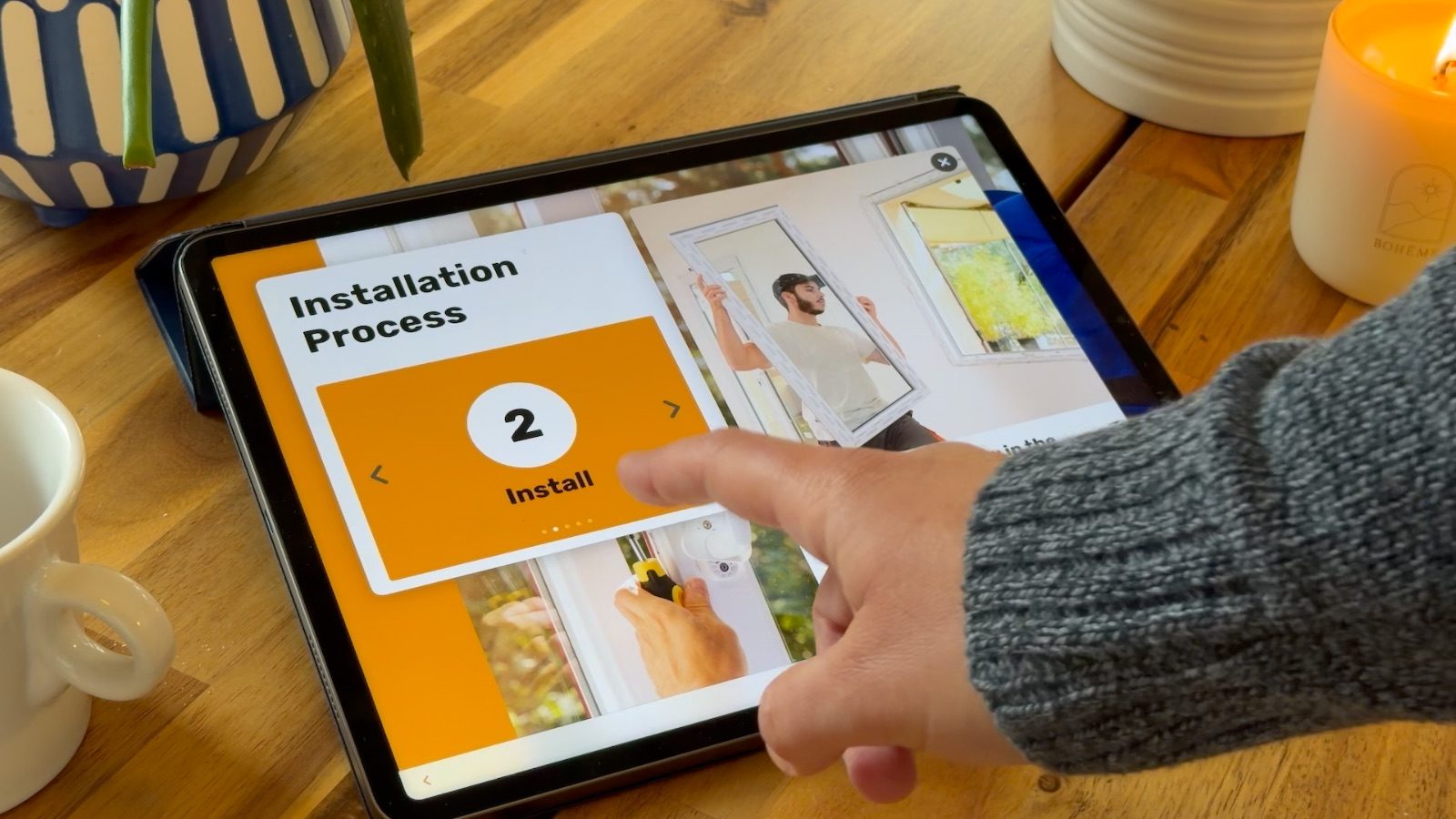 Rep swiping through an installation process page on an iPad at the kitchen table